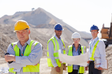 Business people and workers talking in quarry