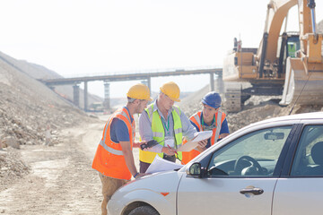 Worker using walkie-talkie in quarry