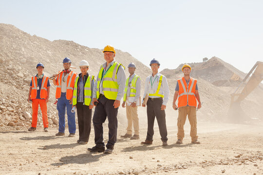 Businessman watching workers in quarry