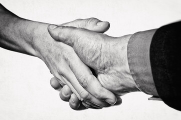 Hands of a man and a woman are connected by a handshake. Metaphor of rescue, love, assistance.