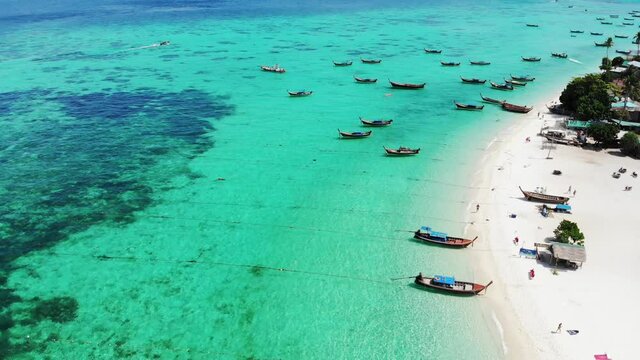 Wooden long-tail boats on coastline in tropical sea at lipe island