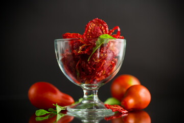 a handful of dried tomatoes and fresh tomatoes