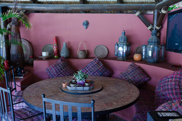 Table and chairs against purple wall