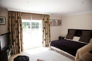 Sun shining through window into luxury bedroom