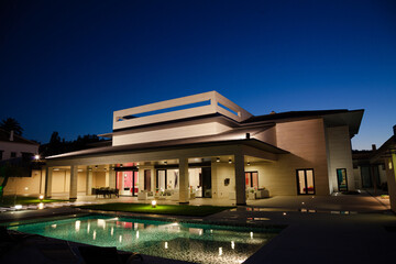 Luxury house and swimming pool illuminated at night
