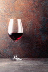 Glass of red wine on rusty a brown background.