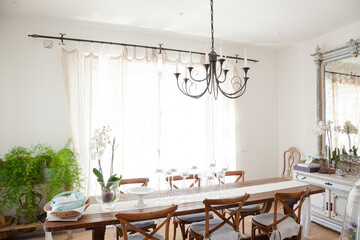 Chandelier over dining table in luxury dining room