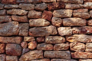 Old brick wall in a summer day. Abstract decorative background or art texture.