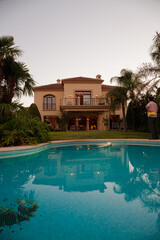 Luxury swimming pool and villa at dusk