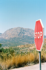stop sign on the road in the mountains in spain during a road trip in summer holiday