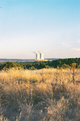 nuclear power station in the middle of nowhere in Spain. Landscape with nuclear power station. Steaming factory producing electricity. Hot summer day. road trip in summer holiday.