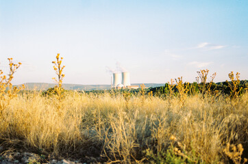 nuclear power station in the middle of nowhere in Spain. Landscape with nuclear power station. Steaming factory producing electricity. Hot summer day. road trip in summer holiday.