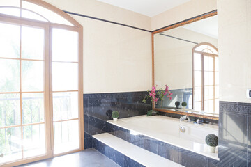 Black marble surrounding bathtub in luxury bathroom
