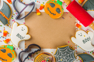 Halloween treats background with sugared Gingerbread cookies and candies, Trick or treat concept top view copy space