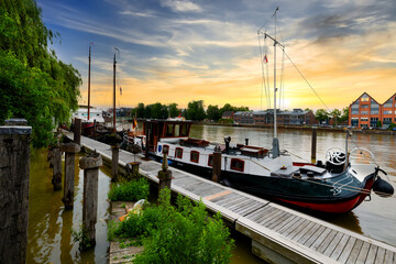 Idyllic river promenade with ships in Leer, East Frisia, Germany