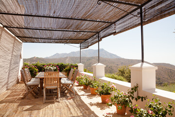 View of mountains from balcony with potted flowers