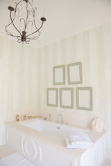 Chandelier over bathtub in luxury bathroom