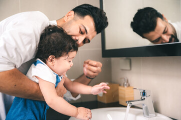 Fototapeta premium father and children happy together at home, cute baby with childhood family people who man are smiling and playing fun with young toddler son, love and care little daughter or boy lifestyle