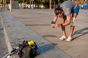 Young latin man taking a photo with mobile after doing exercise