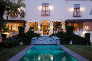 Luxury swimming pool and villa illuminated at night