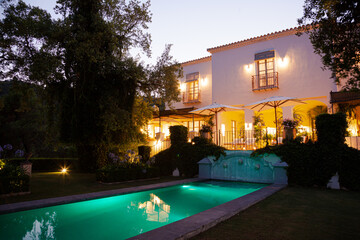 Obraz na płótnie Canvas Luxury swimming pool and villa illuminated at night