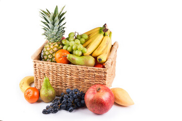 Mix variety of fresh juicy colorful exotic tropical fruits in basket on white background