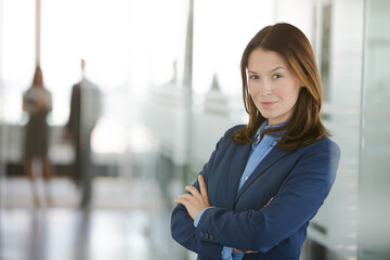 Businesswoman standing in office hallway