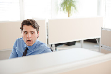 Surprised businessman working in office