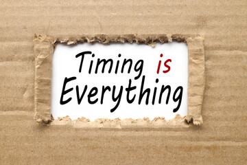 Timing is Everything, text on torn cardboard. black letters on white paper