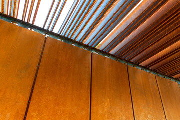 Rust-coated sheet metal forming an abstract image, corten panel and louvers