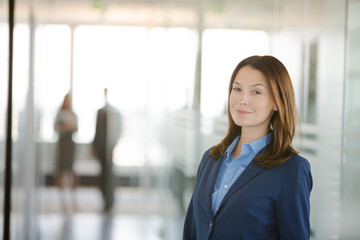 Businesswoman standing in office hallway