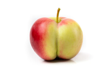 A red-yellow apple in the form of a female buttock on a fucking background.