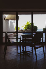 Vertical shot of table and shairs on empty room