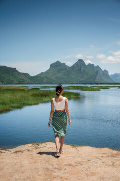 Rear Of Young Asian Woman Standing With Limestone Mountain Range On Wetland At Khao Sam Roi Yot