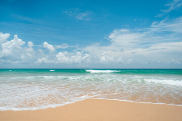 waves nature splashes sand beach on sunlight.blue sea and sky famous beach.