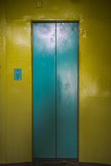 blue elevator doors and yellow wall, elevator in the house