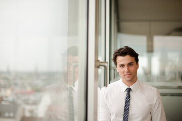 Businessman standing at office window