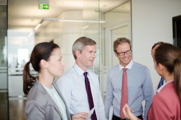 Business people talking in office hallway