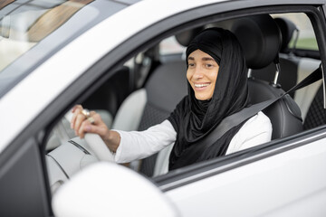 Muslim woman drives a car