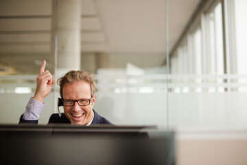 Businessman talking on headset in office