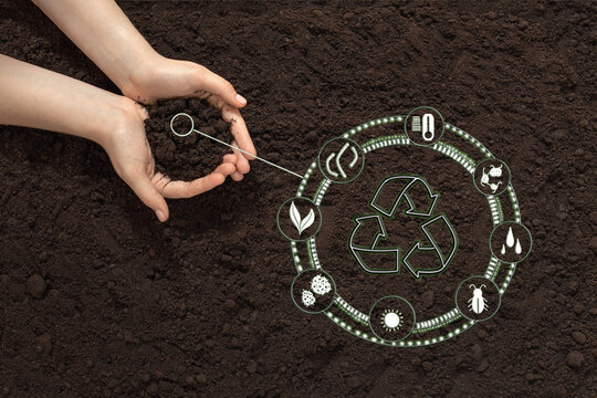 hands with soil on the background of the earth, bio icon, the concept of biodegradable materials, waste-free, eco-friendly recycling, natural fertilizers, organic products and eco friendly farming