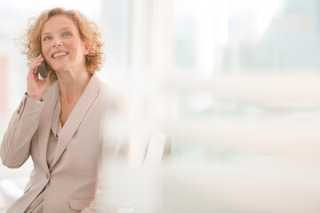 Businesswoman talking on phone in office