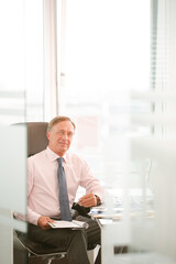 Businessman sitting at desk in office