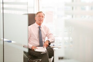Fototapeta premium Businessman sitting at desk in office