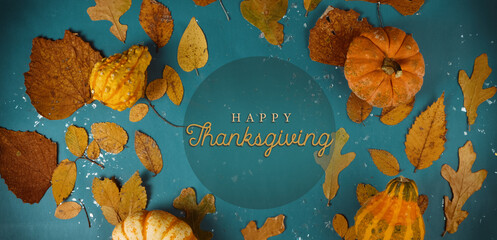 Vibrant Thanksgiving holiday background with top view of fall season pumpkins and leaves.