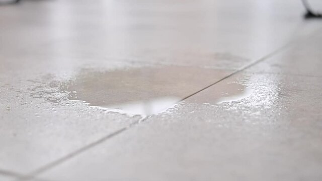 Water drips onto the tiled floor.