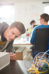 Businessman plugging in printer in office