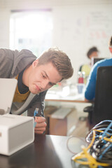 Businessman plugging in printer in office