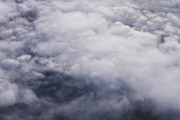 Aerial view scene of the white fluffy clouds cover fully the land