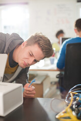 Businessman plugging in printer in office